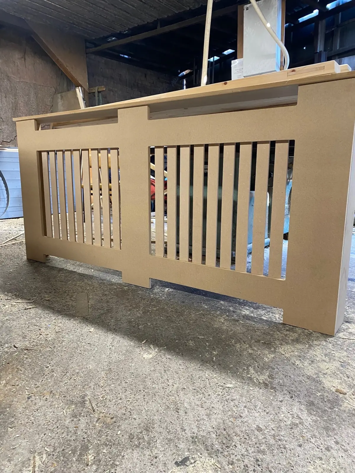 Bespoke slatted MDF radiator cover made in the joinery shop