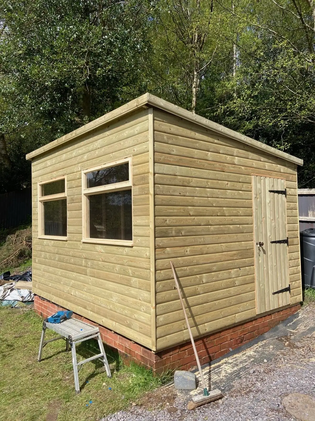 Pent-roof timber garden room on a brick base
