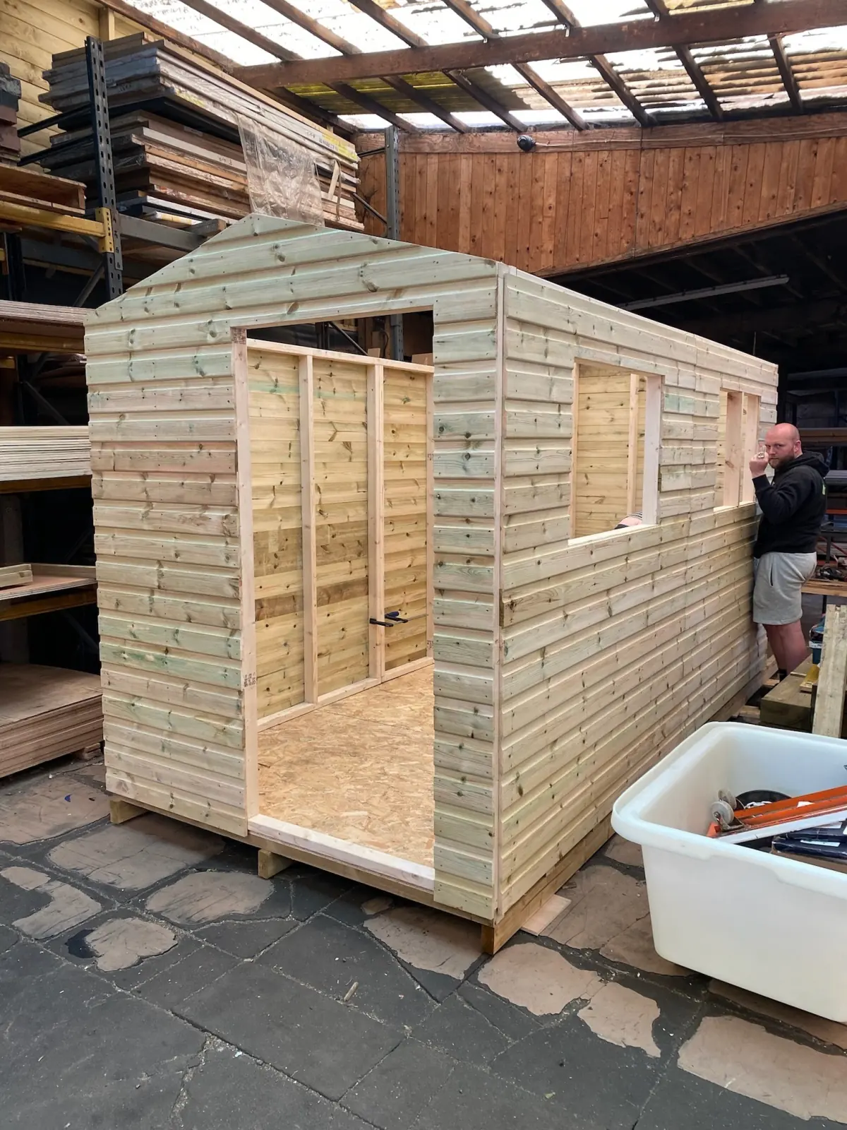 A timber shed being built by hand in the Walsall yard