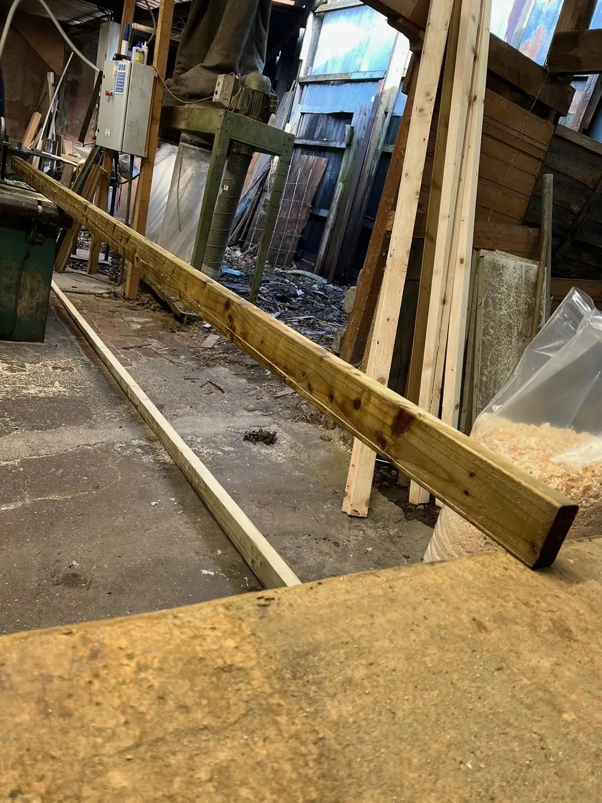 A long treated timber section cut to length in the sawing mill